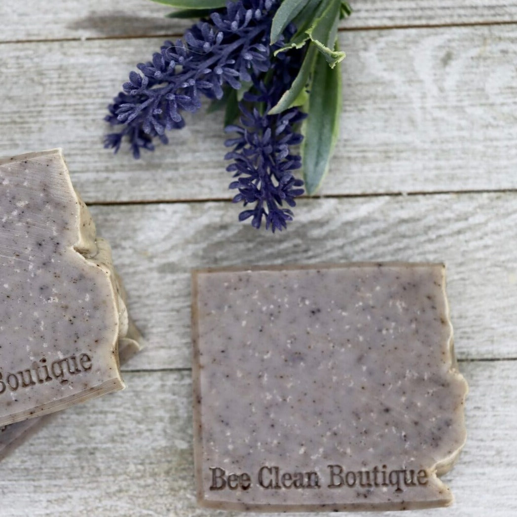 Lavender fog soaps displayed with some lavender on a wooden surface