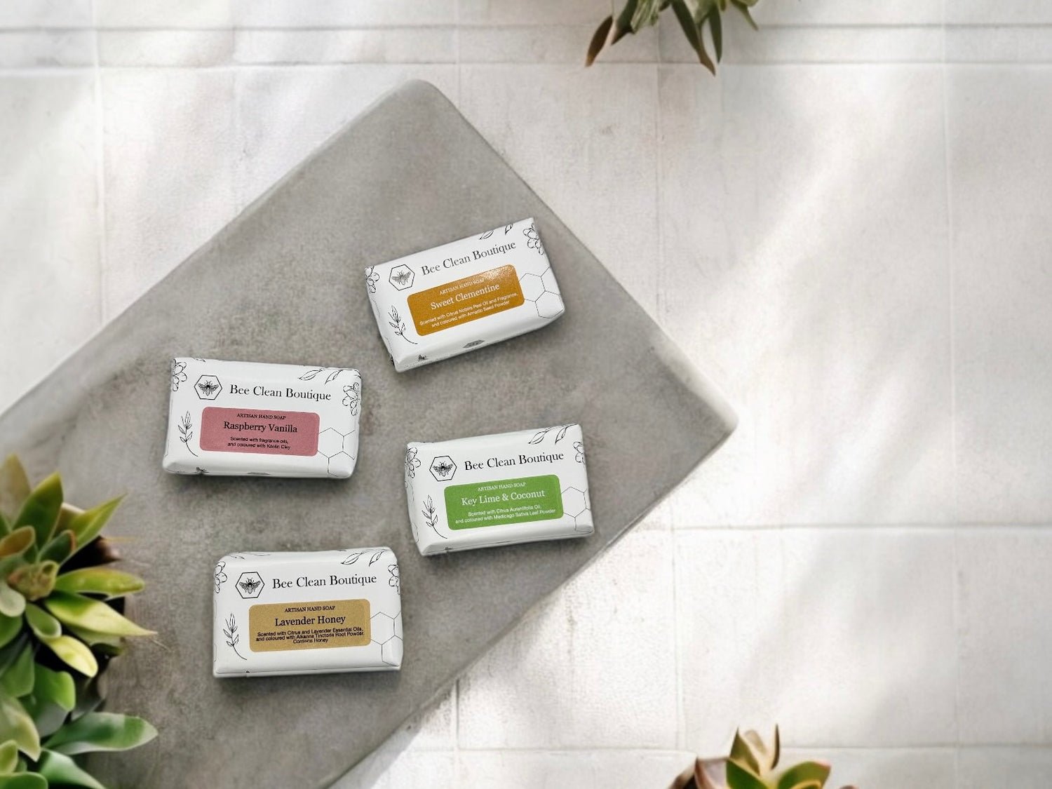 Four hand size artisan bar soaps on a concrete slab on a bathroom counter