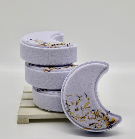 Moon shaped purple bath bombs in a stack