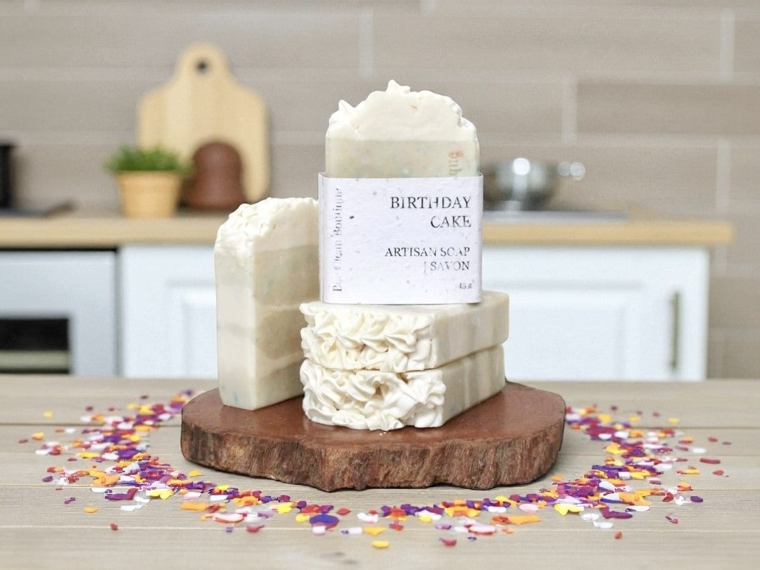 Stack of artisan soap on a wooden platform on kitchen counter with sprinkles all around