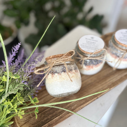 3 jars of artisan bath salt mix on a wooden tray with lavender stems