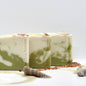 3 bars of salt and sage bar soaps surrounded by sea shells and pink sea salt