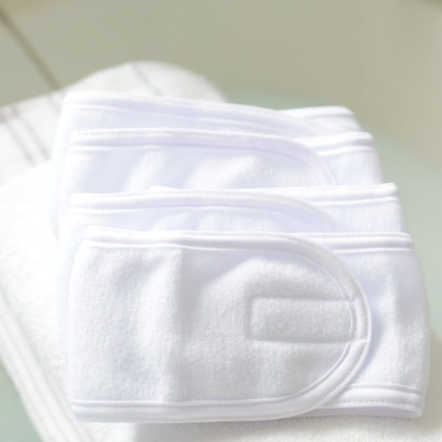 White terry cloth headbands folded in a stack